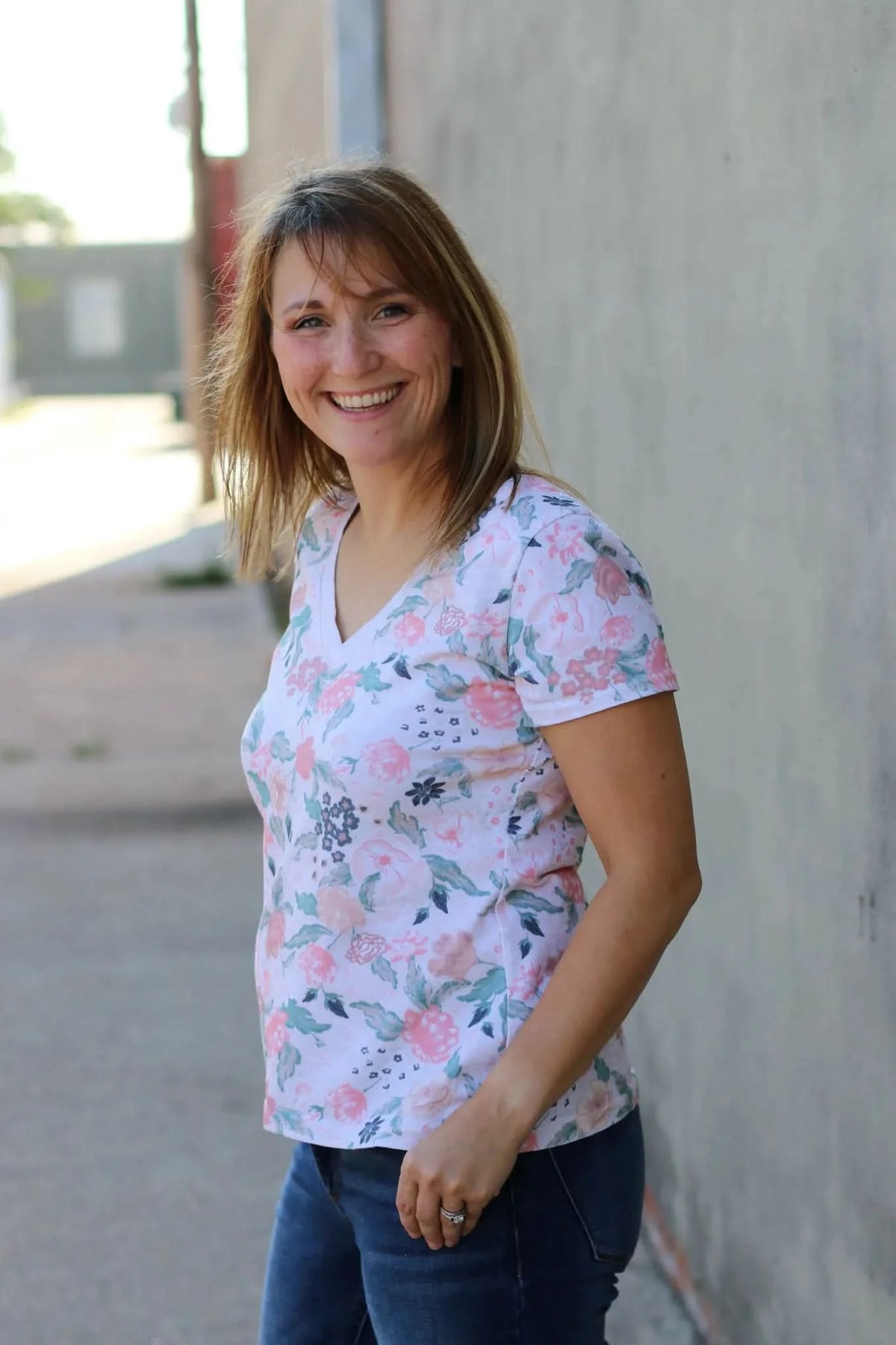 Blush flowers floral print fabric on a model wearing a v-neck t-shirt.