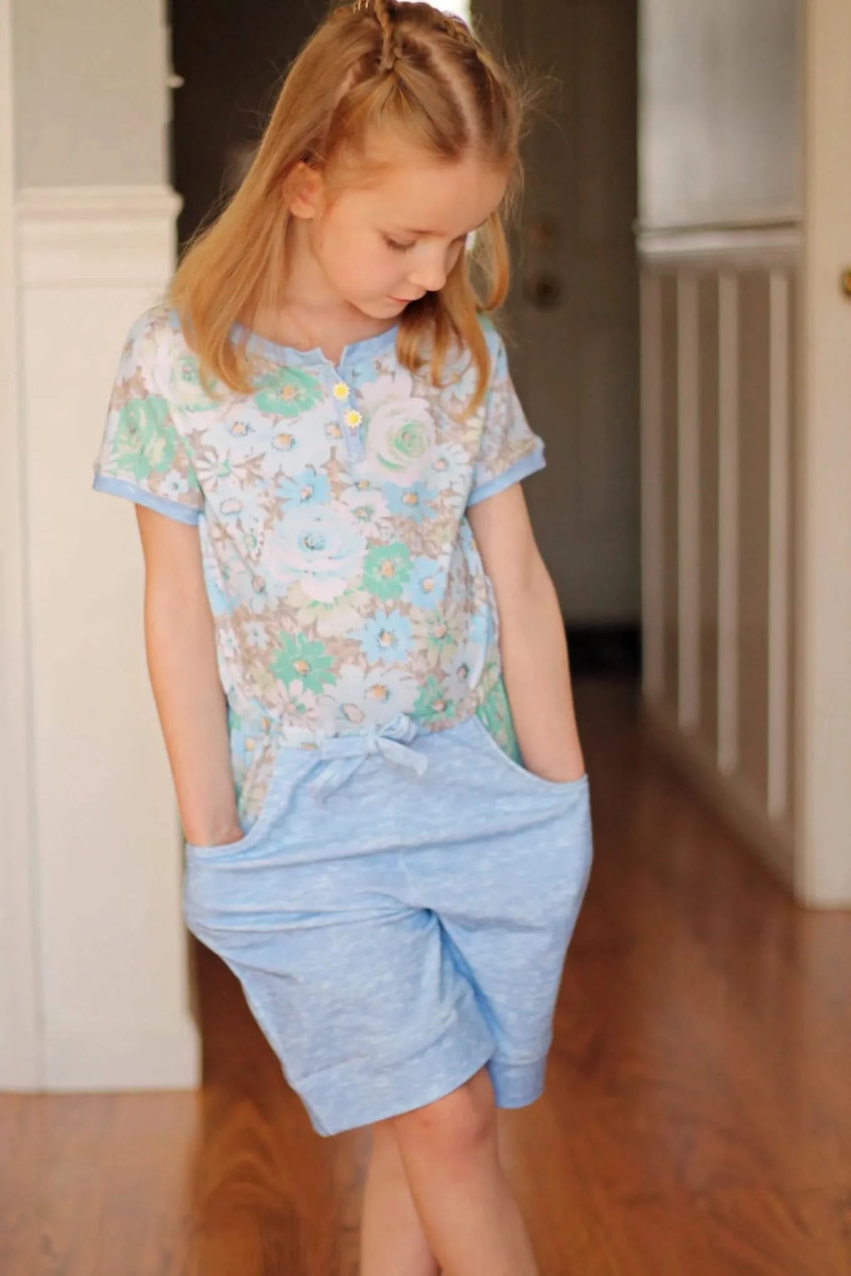 Floral print fabric with wallpaper flowers in green and white tones.