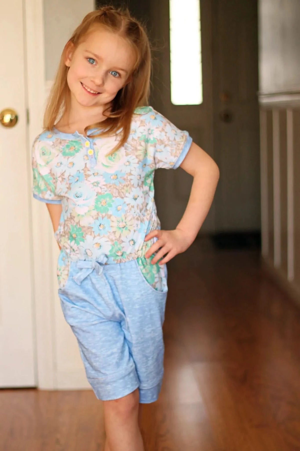 Light blue heather patterned fabric with floral motifs.