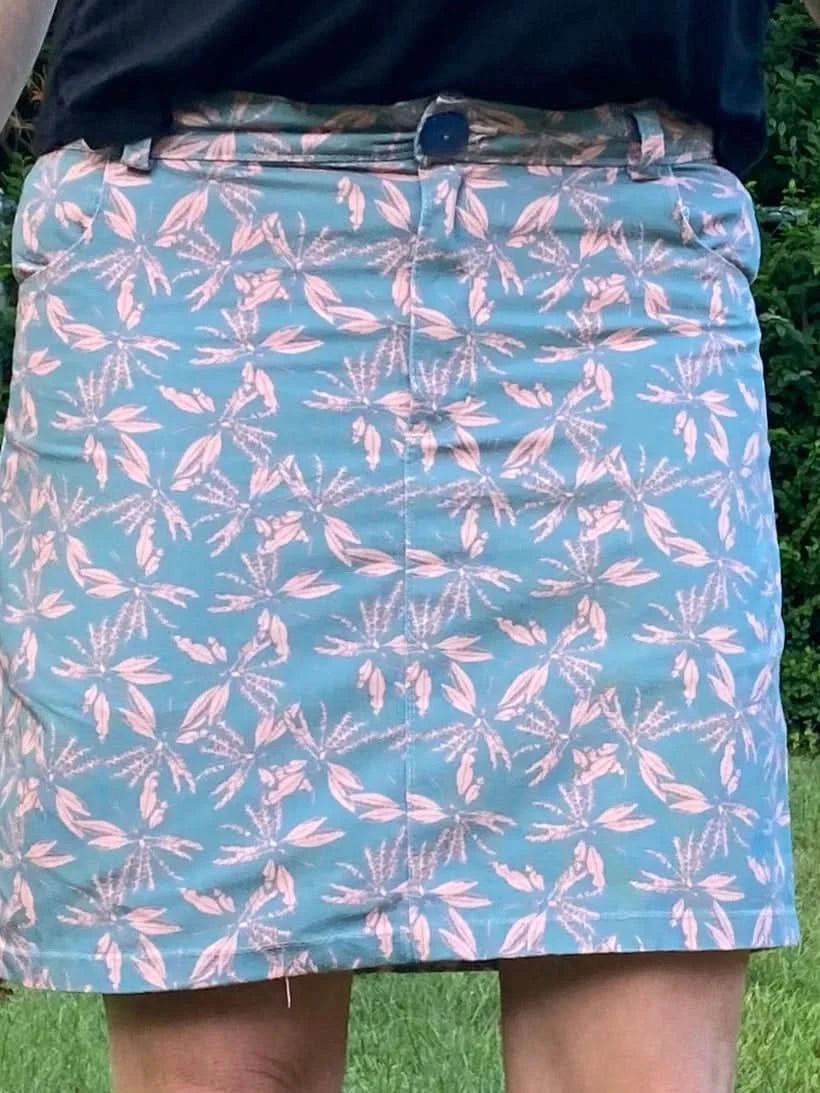 Blush hollow floral print fabric with pink and teal leaf patterns.