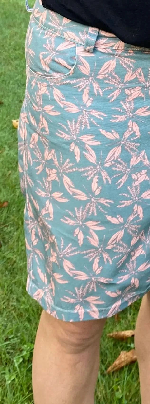 Blush hollow floral print fabric with light blue and pink leaf-like motifs.