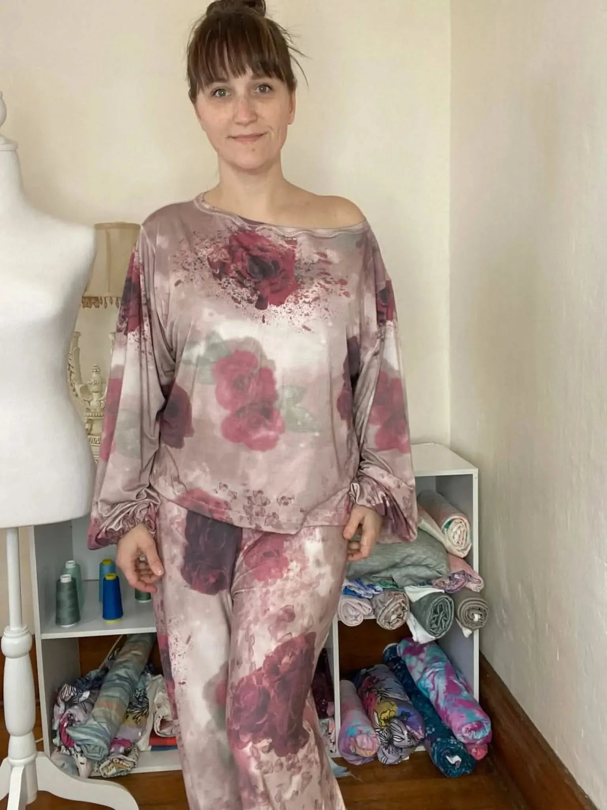 A woman models a two-piece outfit made from shattered roses floral fabric.