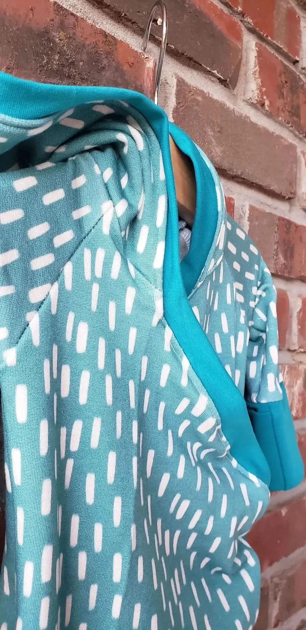 Blue dash pattern print fabric from WayMaker Fabrics, featuring white dashes on a teal background.