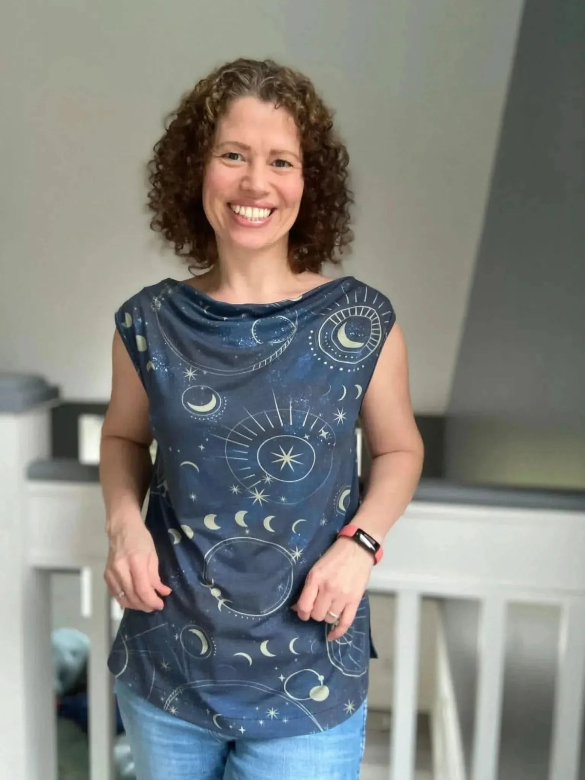 Navy fabric with celestial sky print of moons, suns, and galaxies.