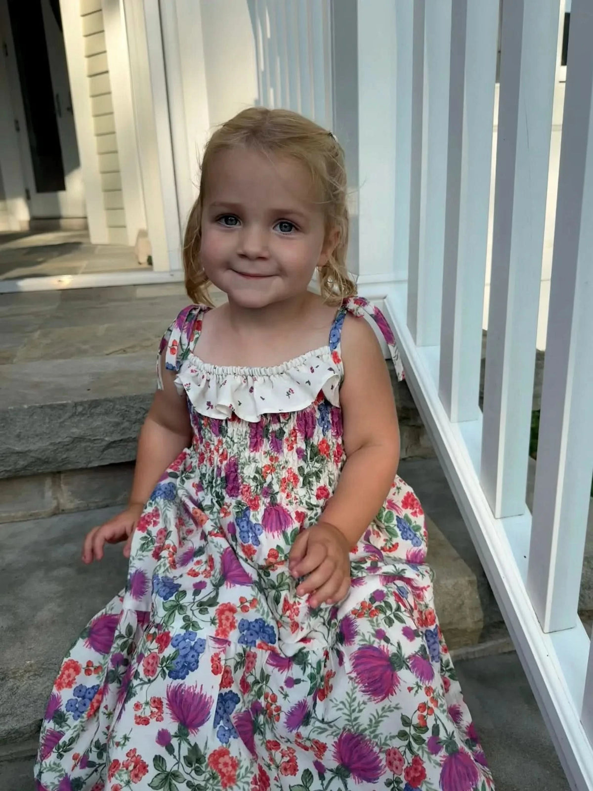 White fabric with colorful thistle and floral print pattern.