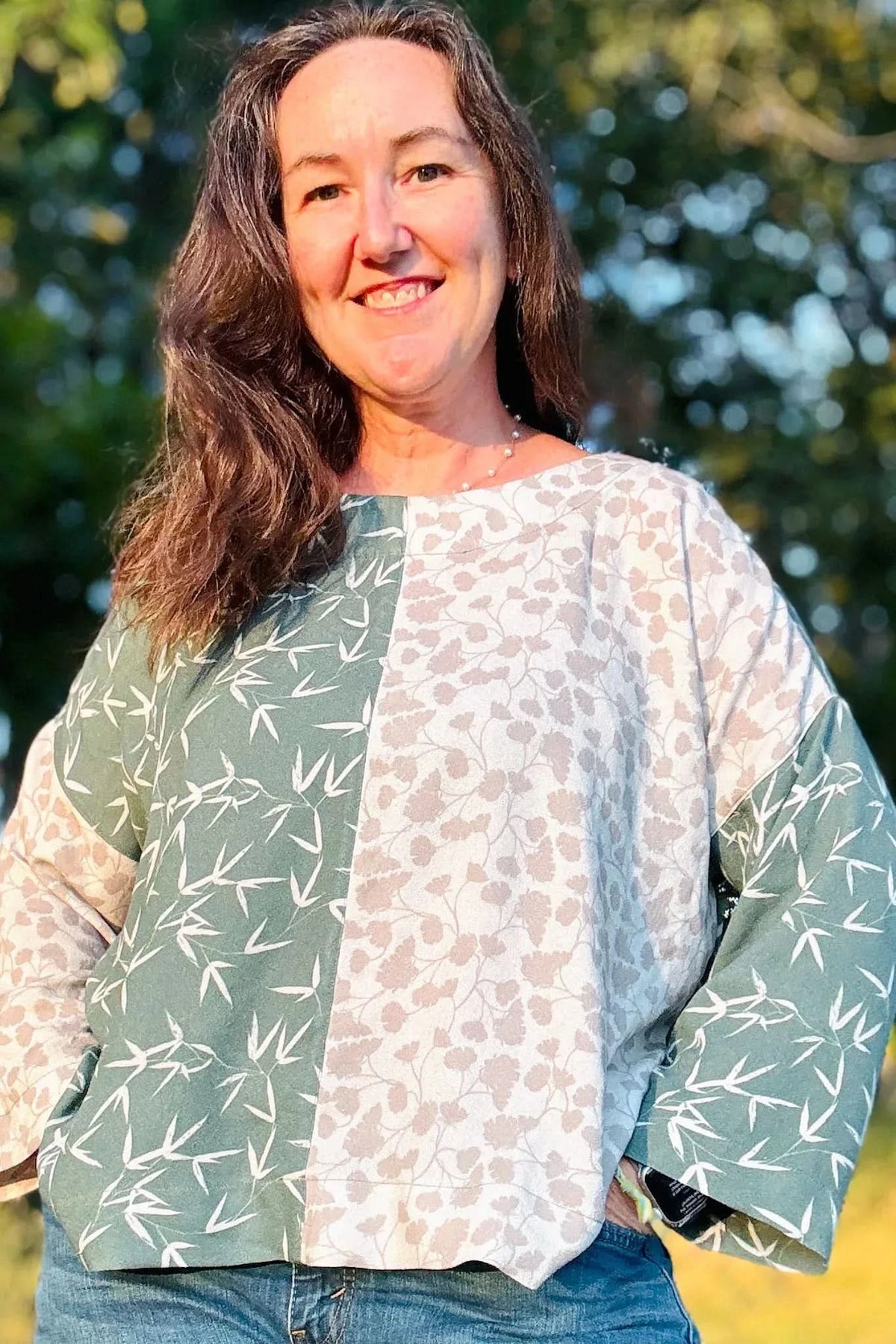 Green leaf print fabric with nature-inspired leaf motifs on a light background.