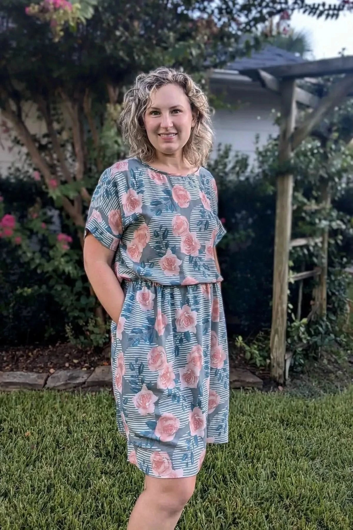 Wild Rose floral print fabric in green with pink roses.