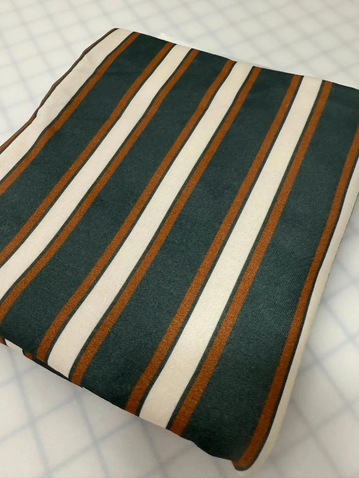 Verdant Stripes fabric with green and white stripes on a neutral background.