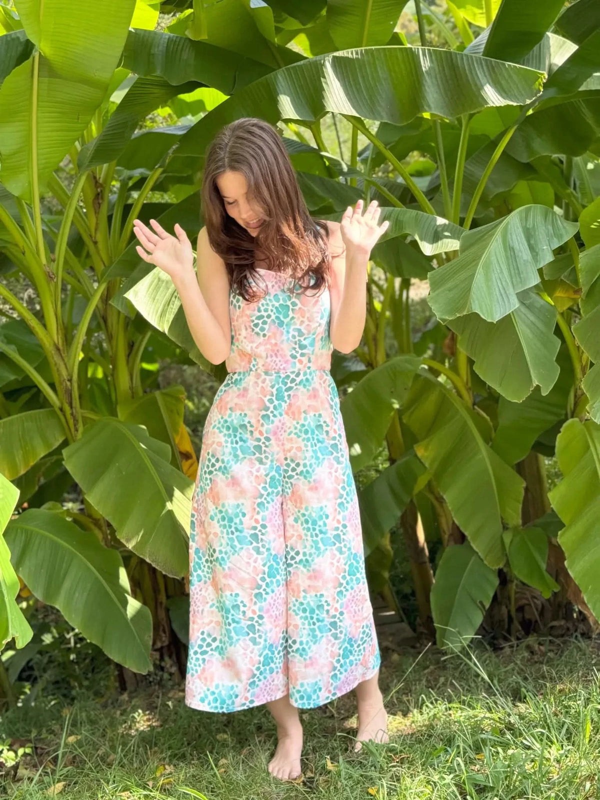 Vibrant abstract print fabric with wild heart motifs in pink and green tones.