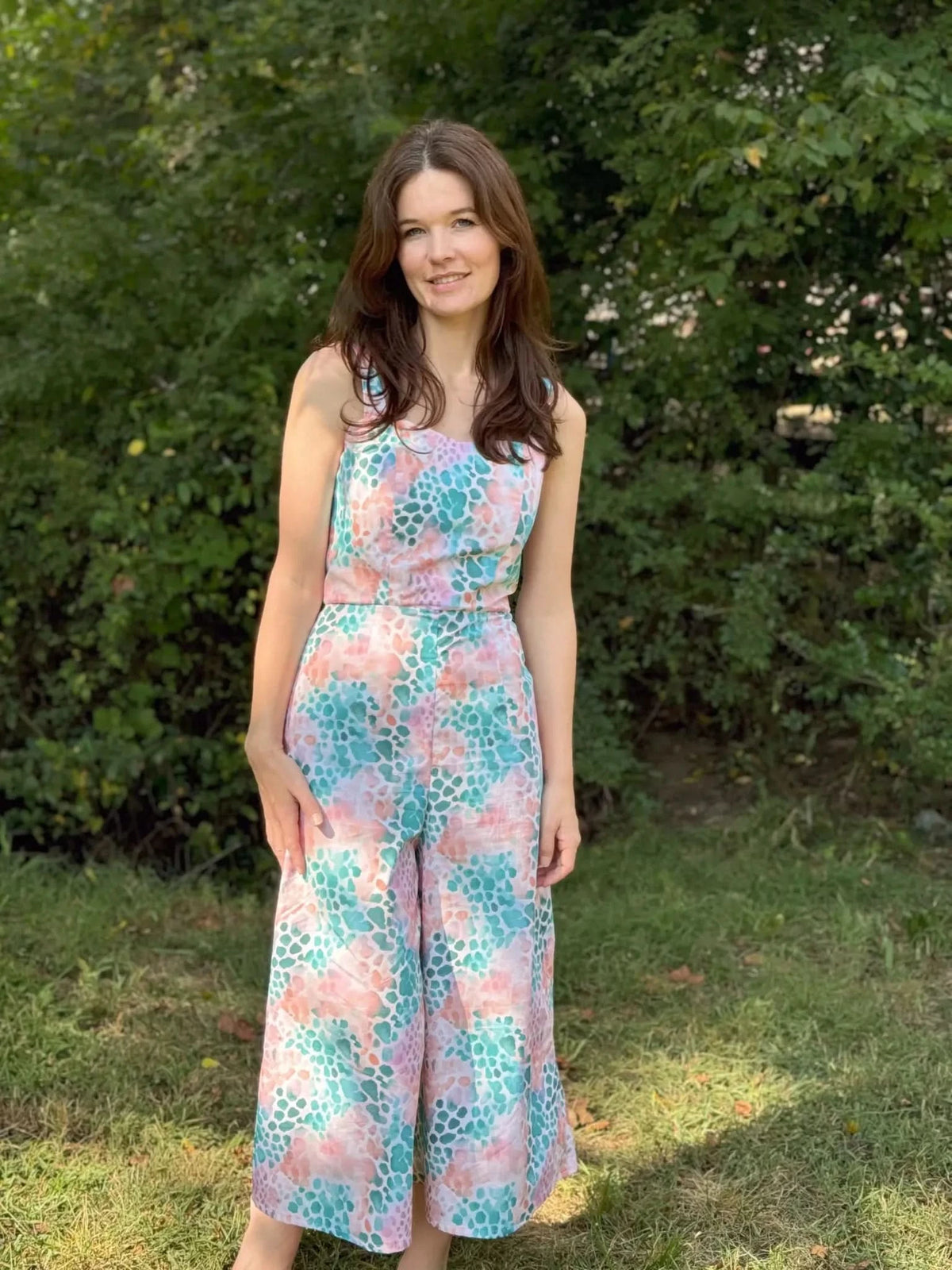 Vibrant abstract print fabric with wild heart patterns in pink and green hues.