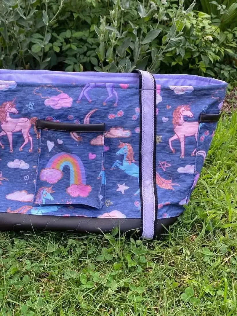 Navy fabric with a whimsical unicorn print featuring pink unicorns, rainbows, and stars.