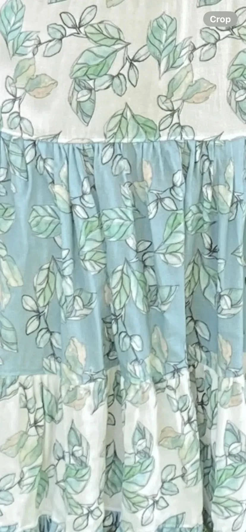 Willow Mist botanical floral fabric with green leaf print on white and blue base.