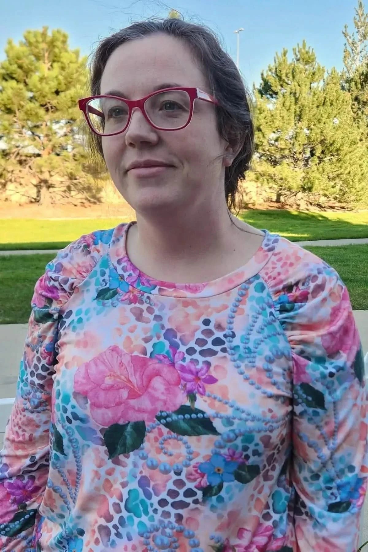 Vibrant tropical fabric with wild hibiscus floral print in pink, orange, and blue.