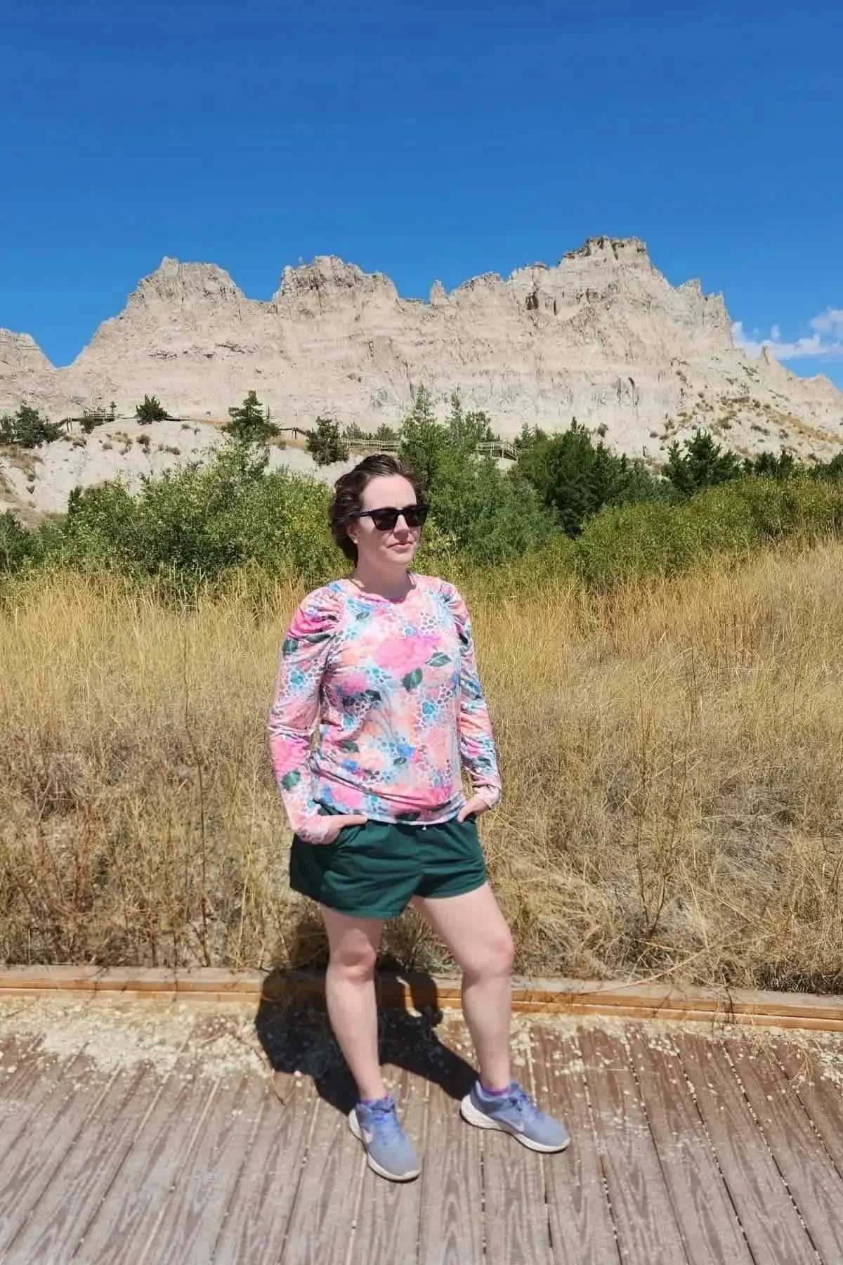 Vibrant tropical hibiscus floral print fabric with pink flowers on a light background.