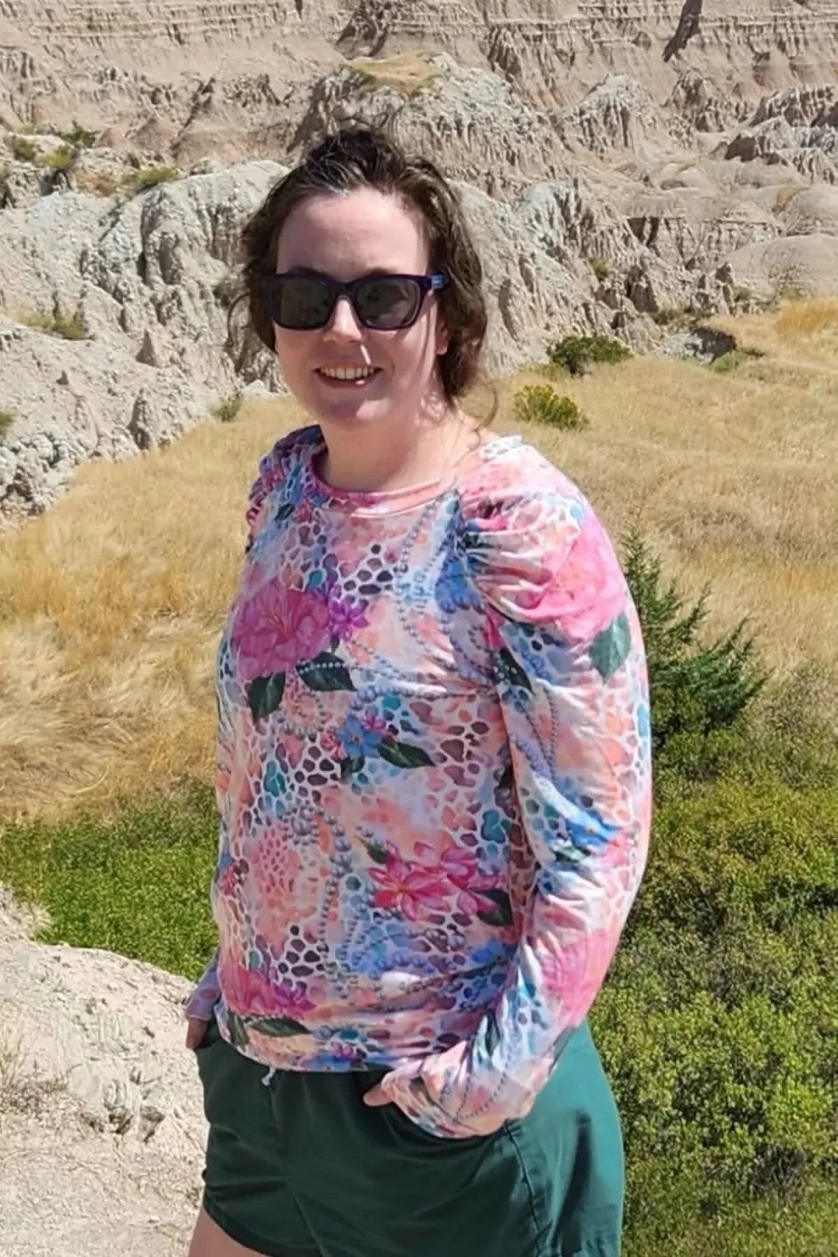 Vibrant tropical hibiscus floral print fabric in pink and green hues.