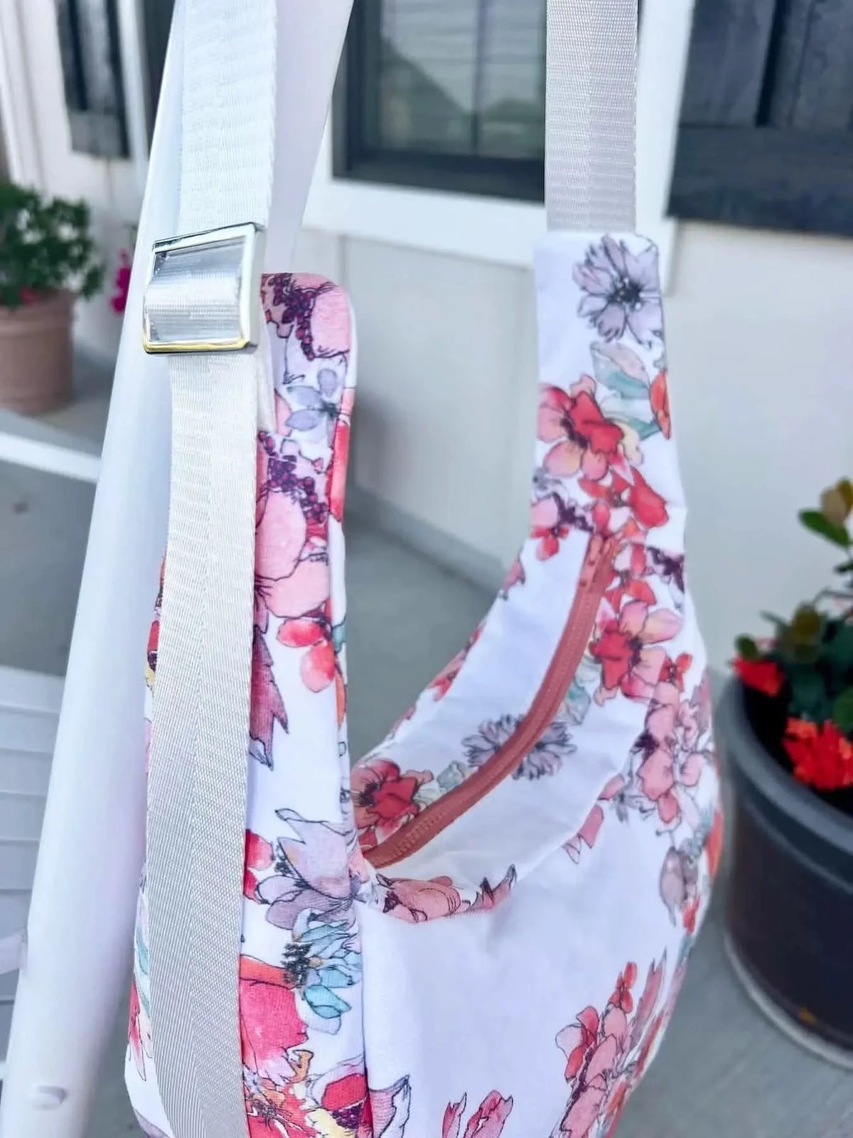 White fabric with pink and purple floral Memory Garden print, shown in sewn bag form.