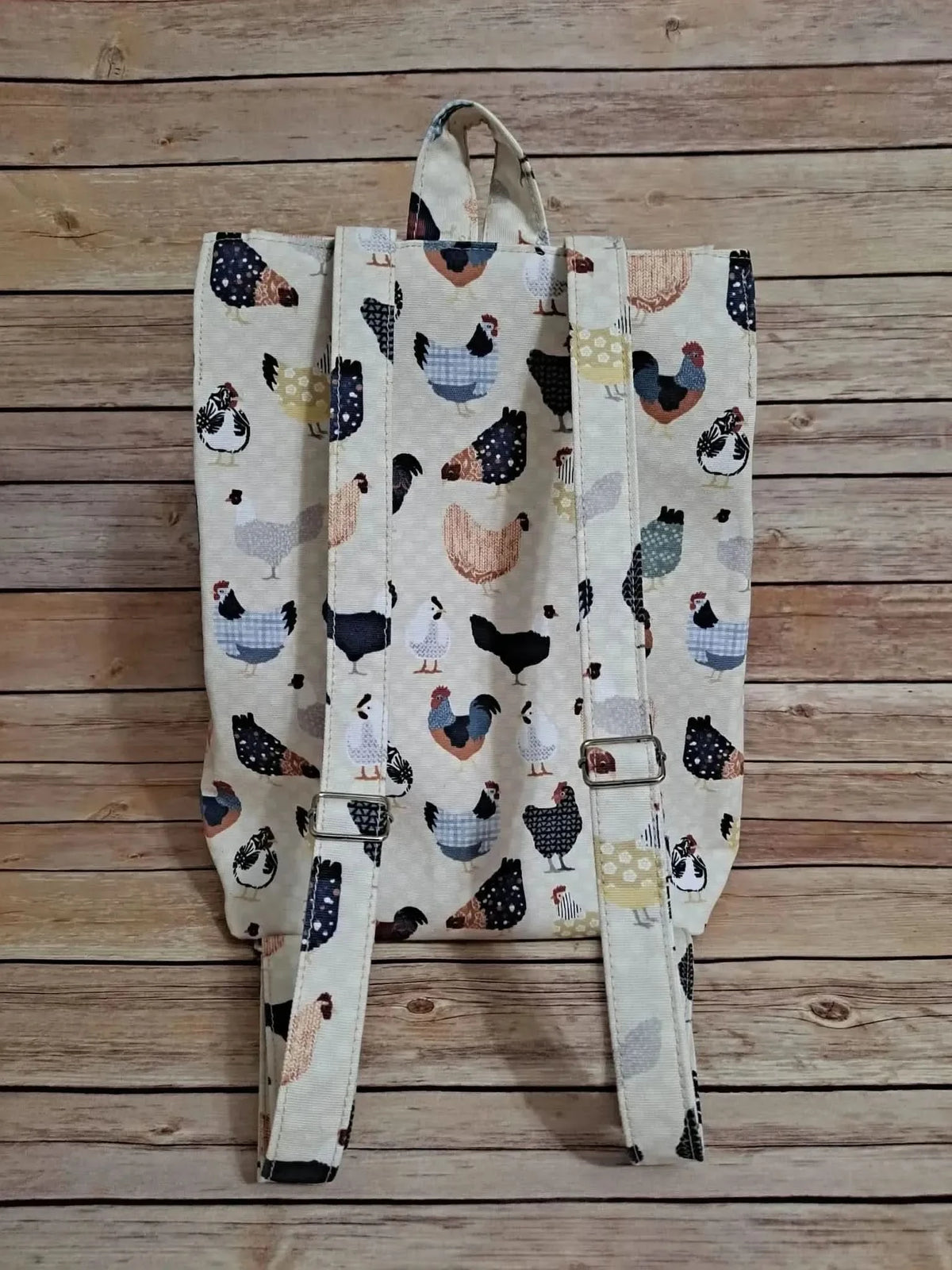 Patchwork fabric featuring a colorful print of various chickens on a light background.