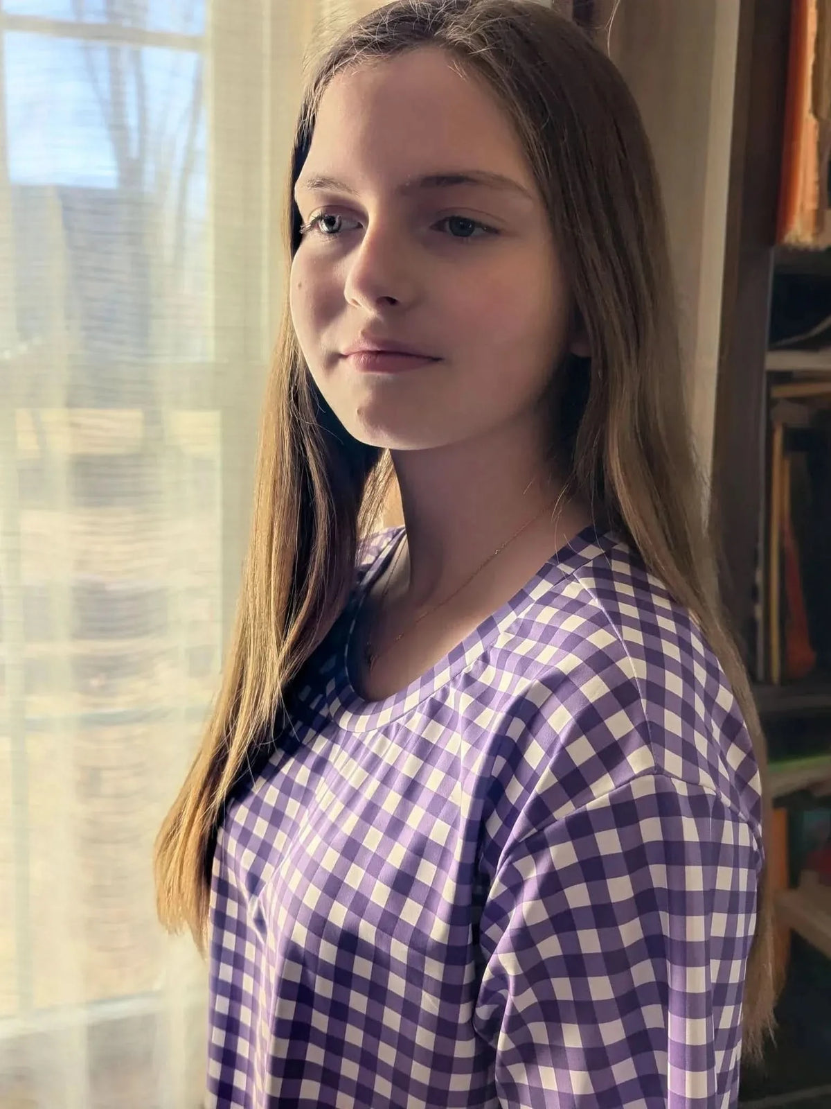 Violet gingham fabric with purple and white checkered pattern on a woven base.
