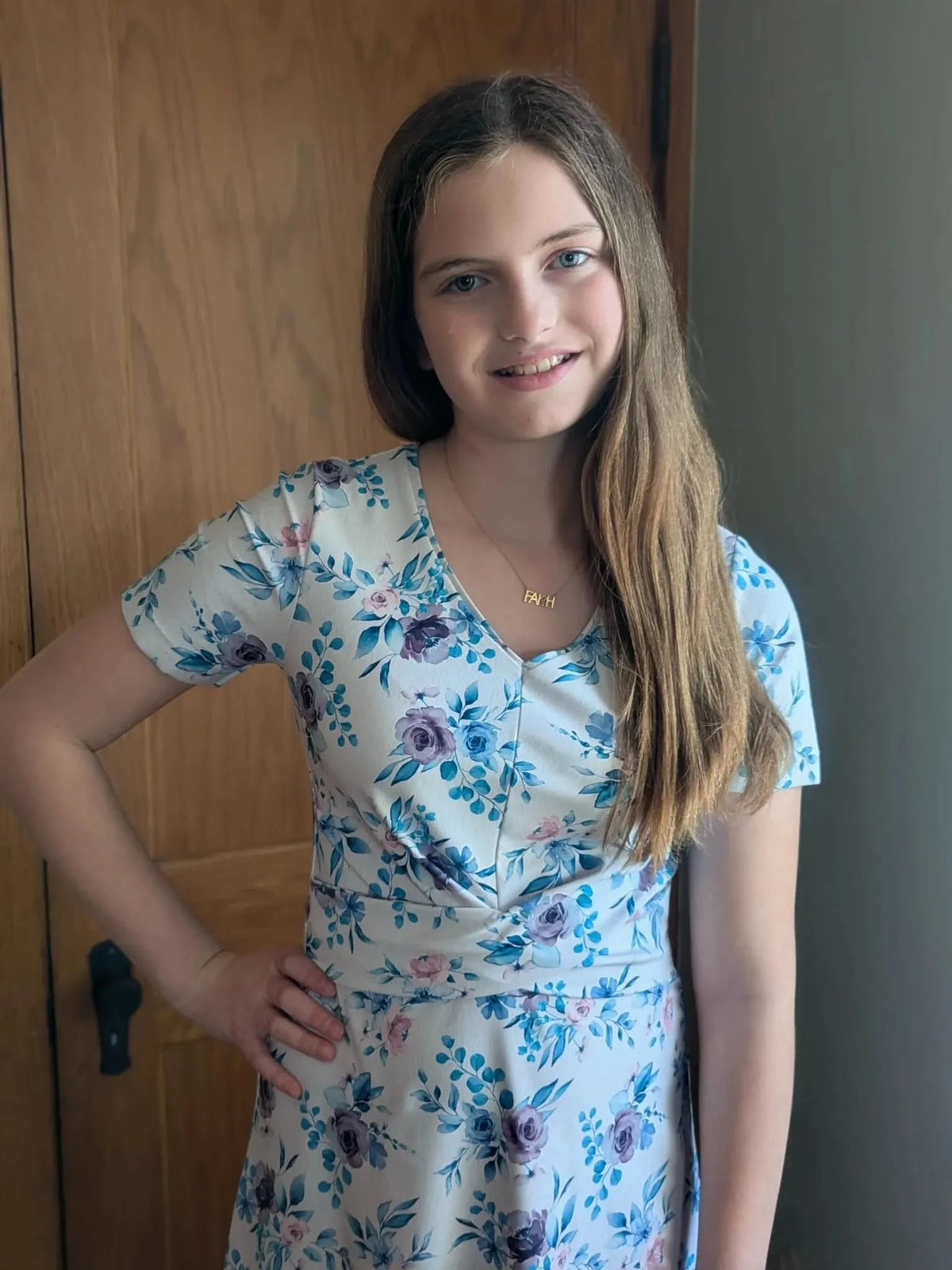 Blue watercolor floral print fabric with soft purple and white flowers.