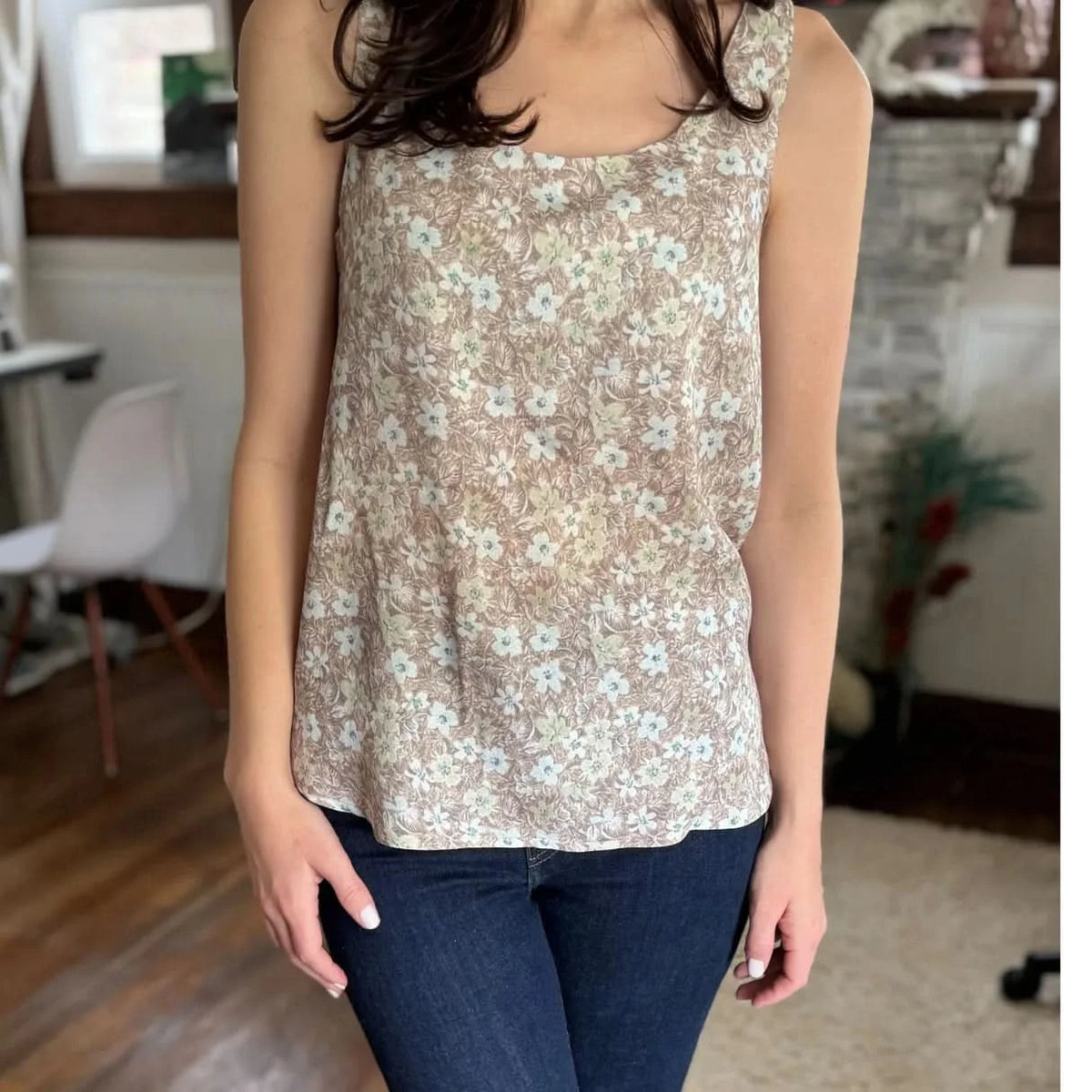 Brown leaves botanical print fabric in neutral tones on a light background.