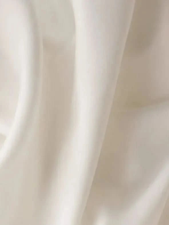 Close-up of white off-white WayMaker fabric with smooth, flowing texture.