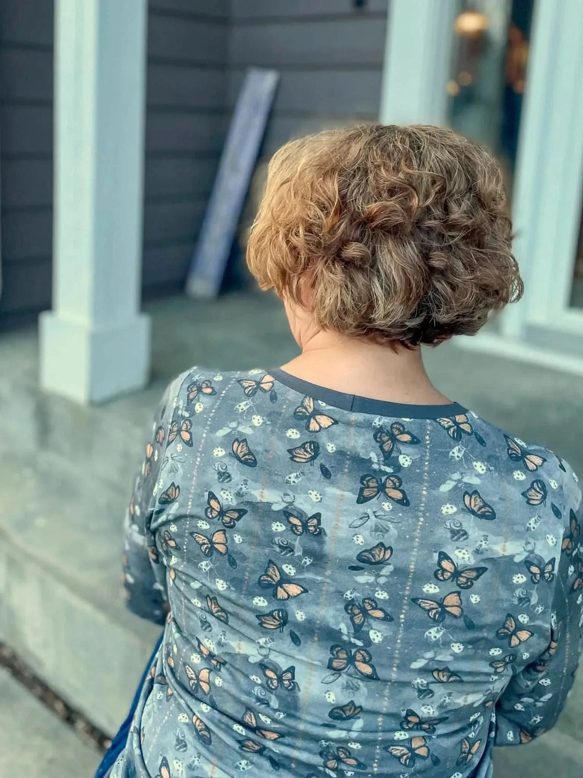 Gray fabric featuring a subtle monarch butterfly print pattern.