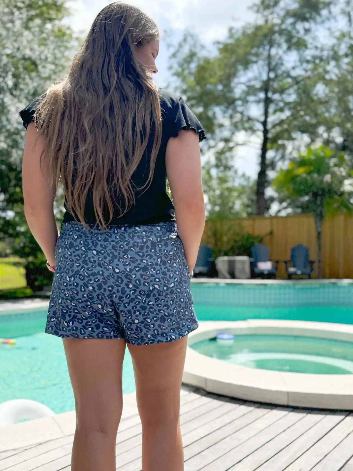 Teal leopard animal print fabric with summer pattern on stretch material.