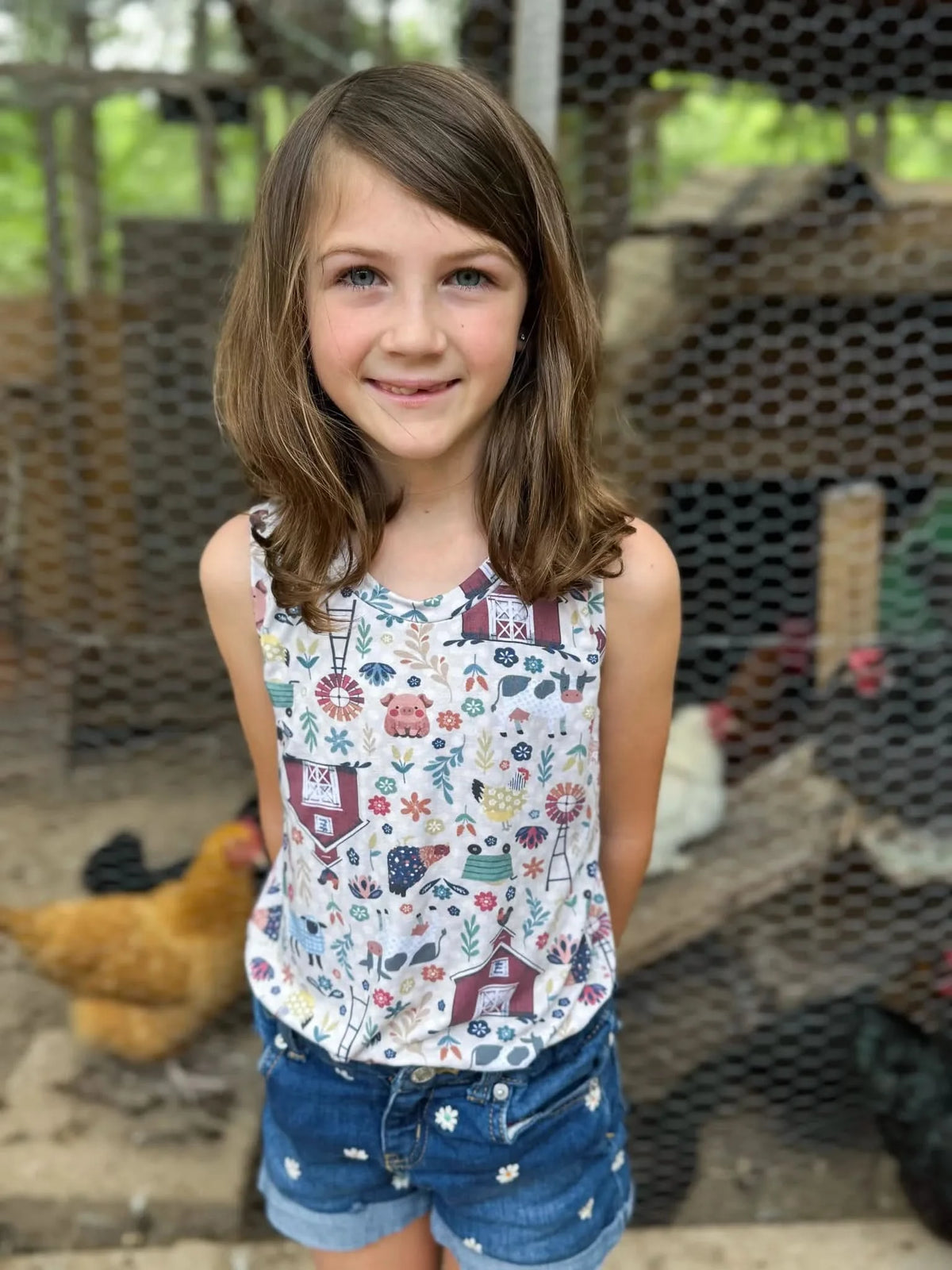 White fabric with colorful farm animals, barn, and plants print.
