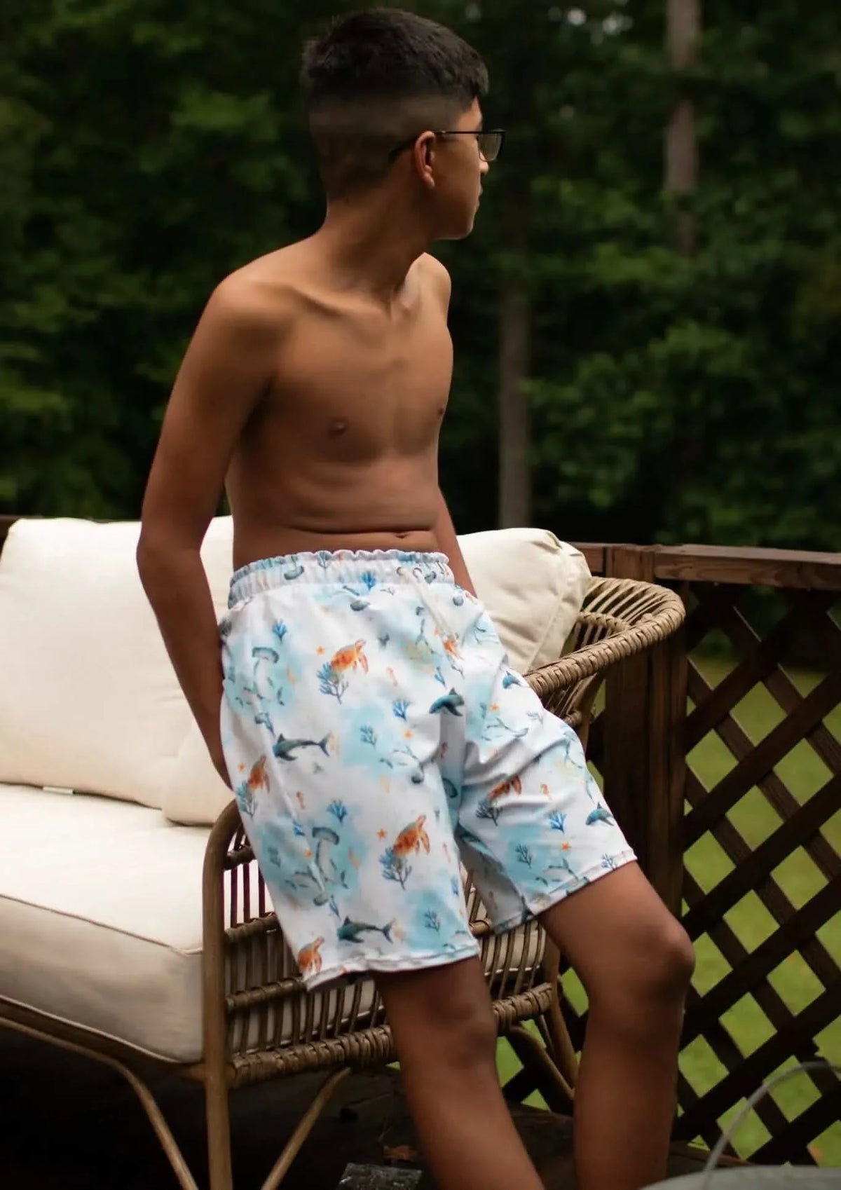 Blue aquatic print fabric with under-the-sea pattern on a light background.