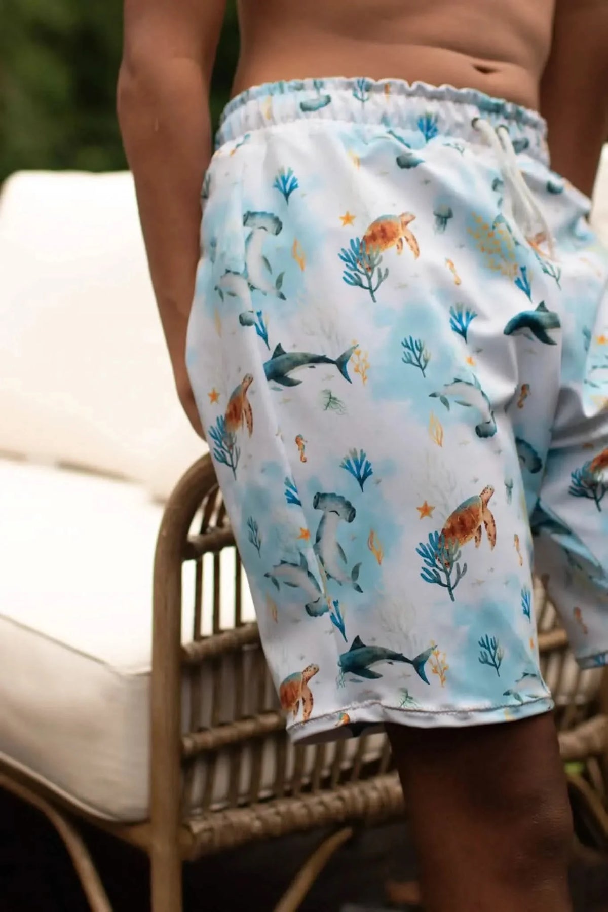 Blue aquatic print fabric featuring sea creatures like fish and coral on a light background.