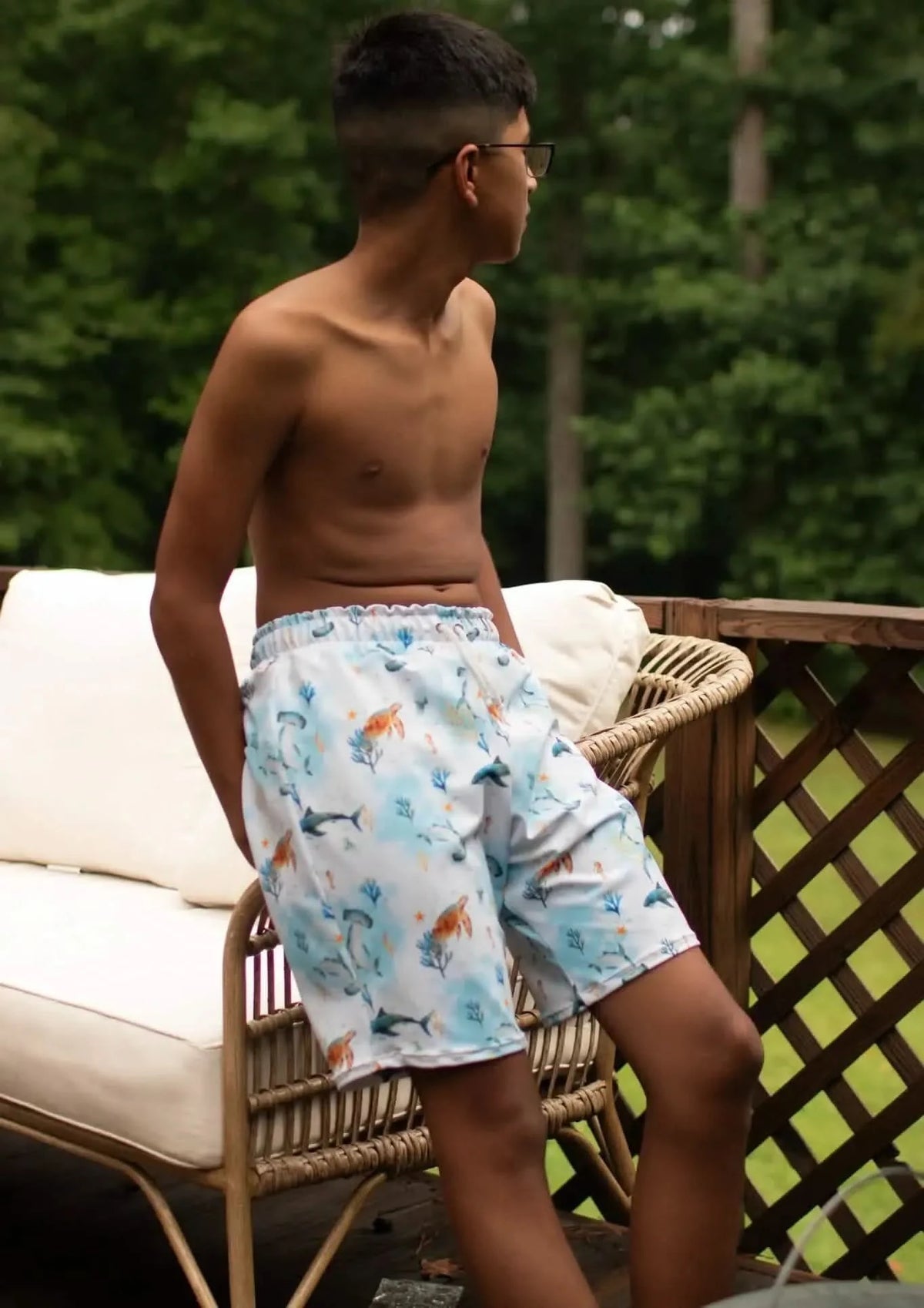 Blue aquatic print fabric with under-the-sea pattern on a white background.