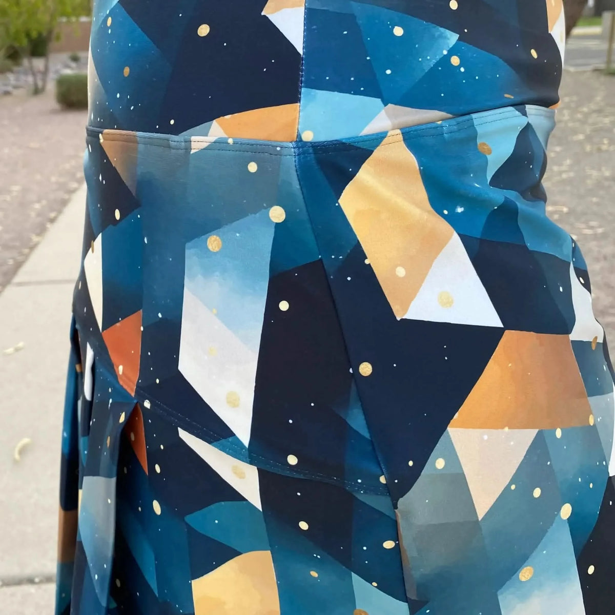 Blue and gold abstract celestial fabric with geometric shapes and star motifs.