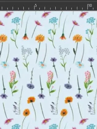 Light blue fabric printed with scattered wildflowers in pink, orange, purple, and blue.