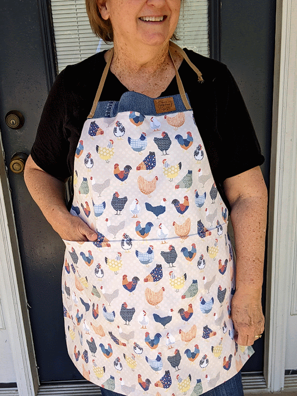 Fabric with a patchwork chickens print in various colors and patterns.