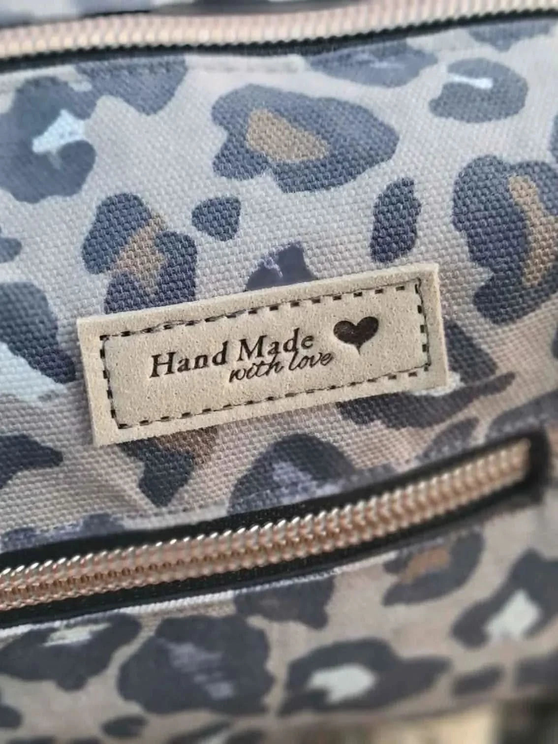 Autumn leopard print fabric with gray and brown spots on a light background.