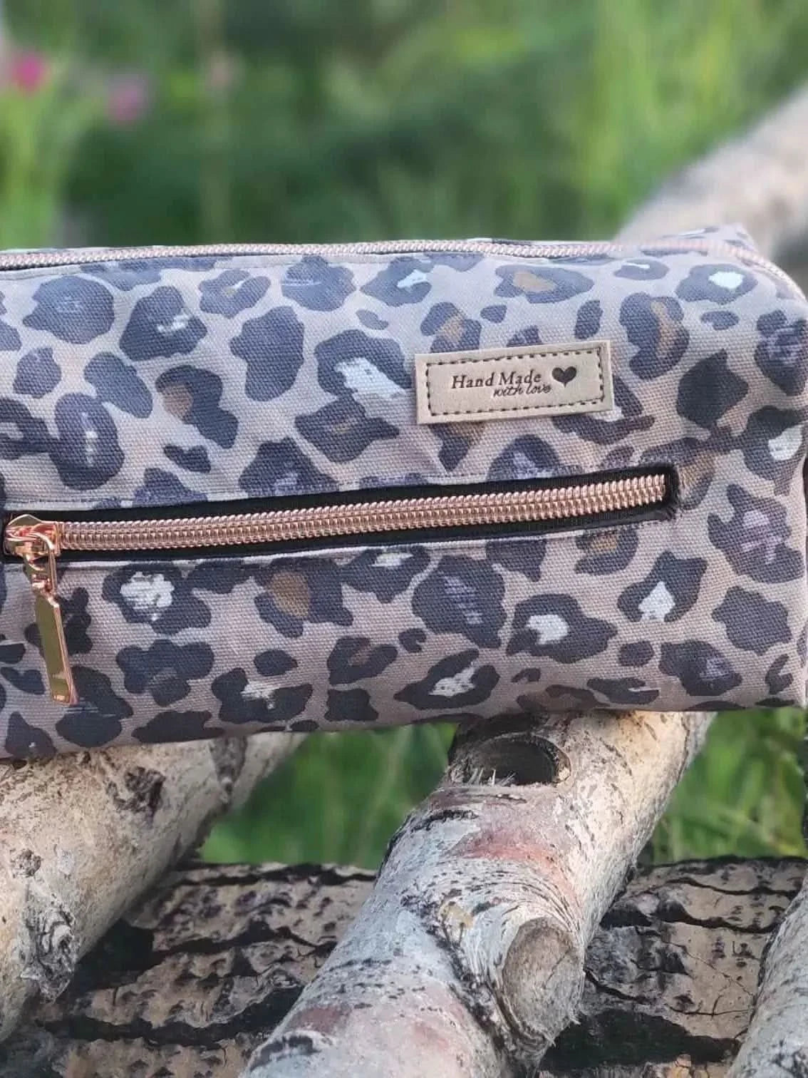 Autumn leopard print fabric with gray and brown spots on a woven textile.