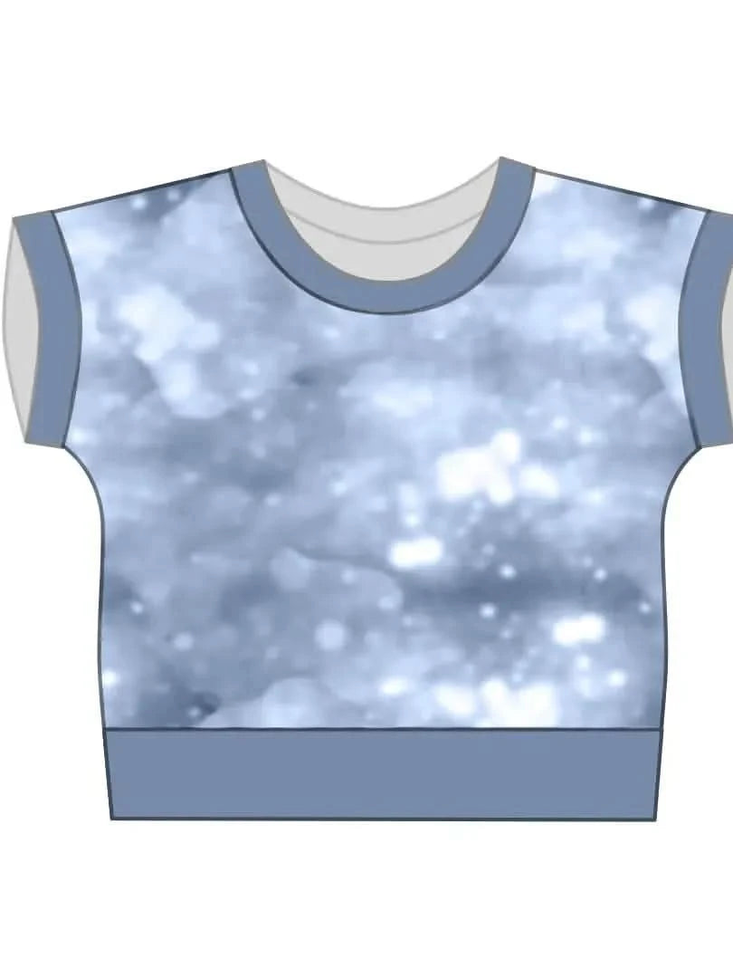 A blue t-shirt with a blurred glitter celestial pattern.