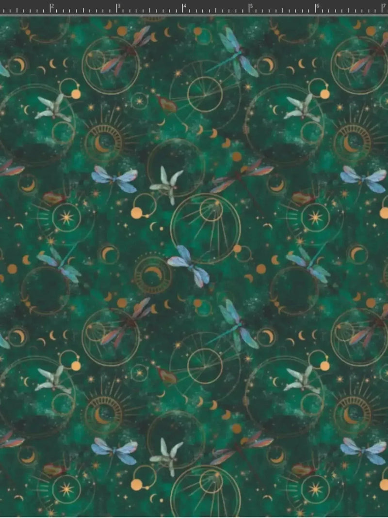 Green fabric with celestial dragonflies, moons, suns, and lilies in a fantasy print.