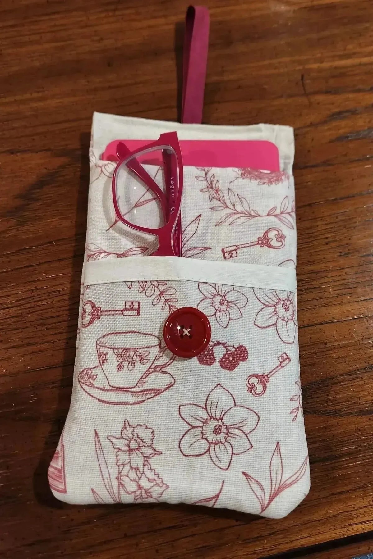 Red tea and toile faith-based print fabric with cups, keys, and flowers.