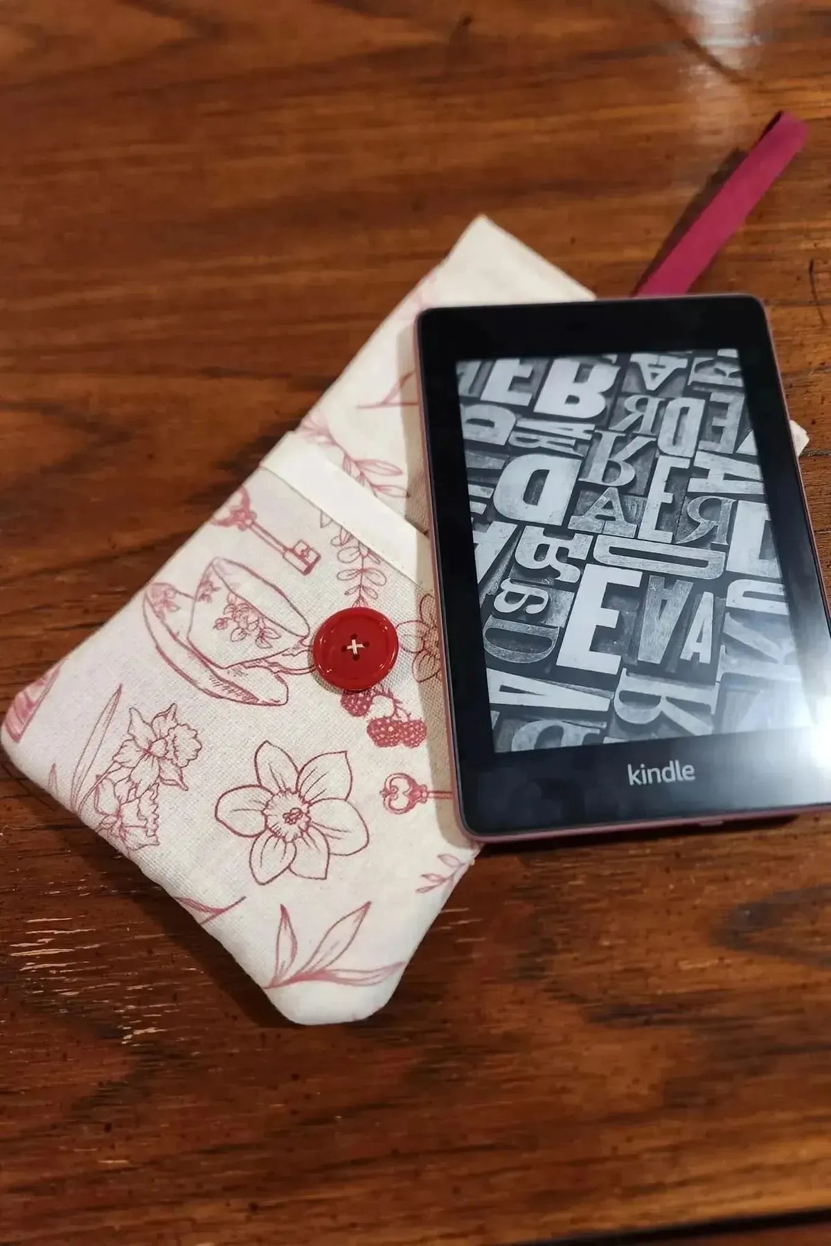 Red tea and toile faith-based print fabric with floral motifs and a button detail.