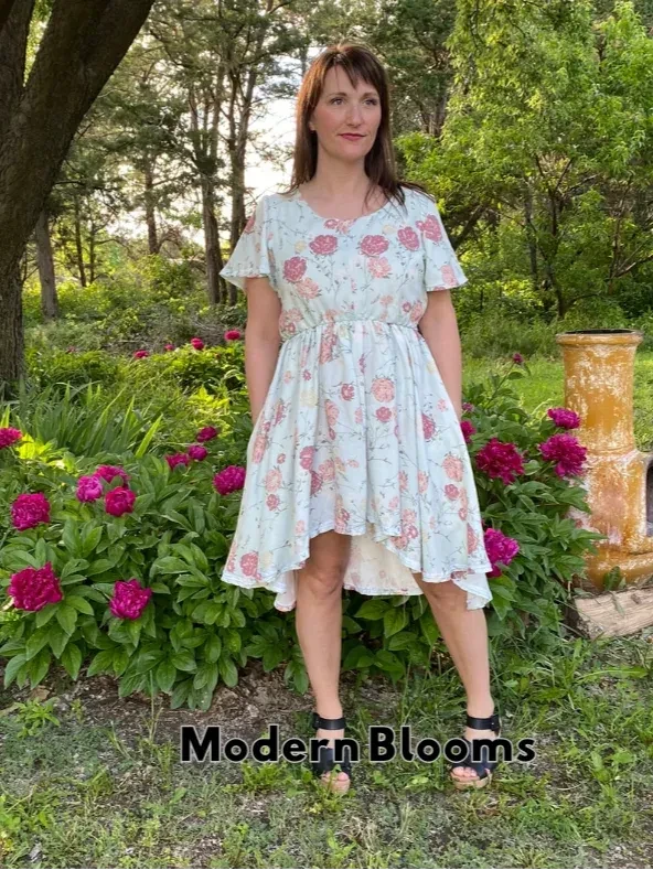 Woman in a light blue floral dress with a high-low hem.