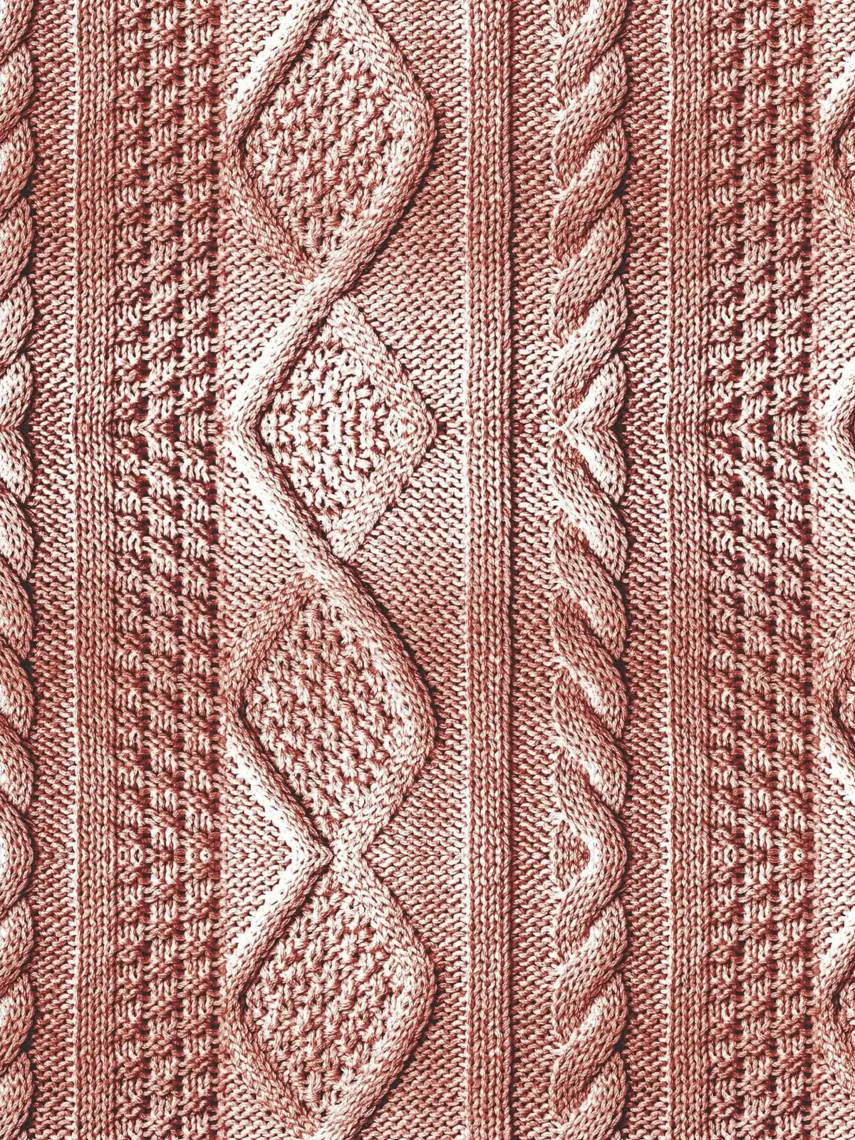 A close-up of rose-colored cable knit fabric with various textured patterns.
