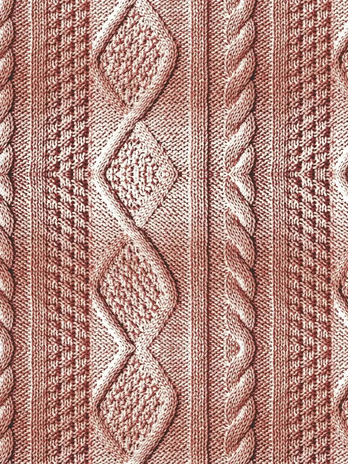 Pink textured knit fabric with rose cable pattern and diamond motifs.