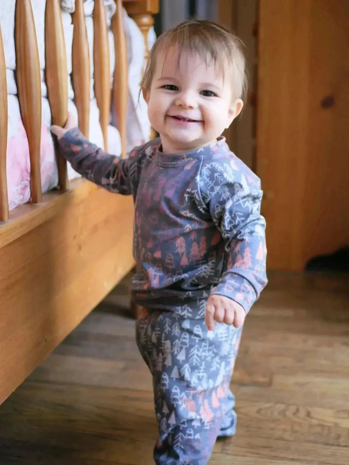 Dark fall trees woodland print fabric with autumn theme on a soft base.