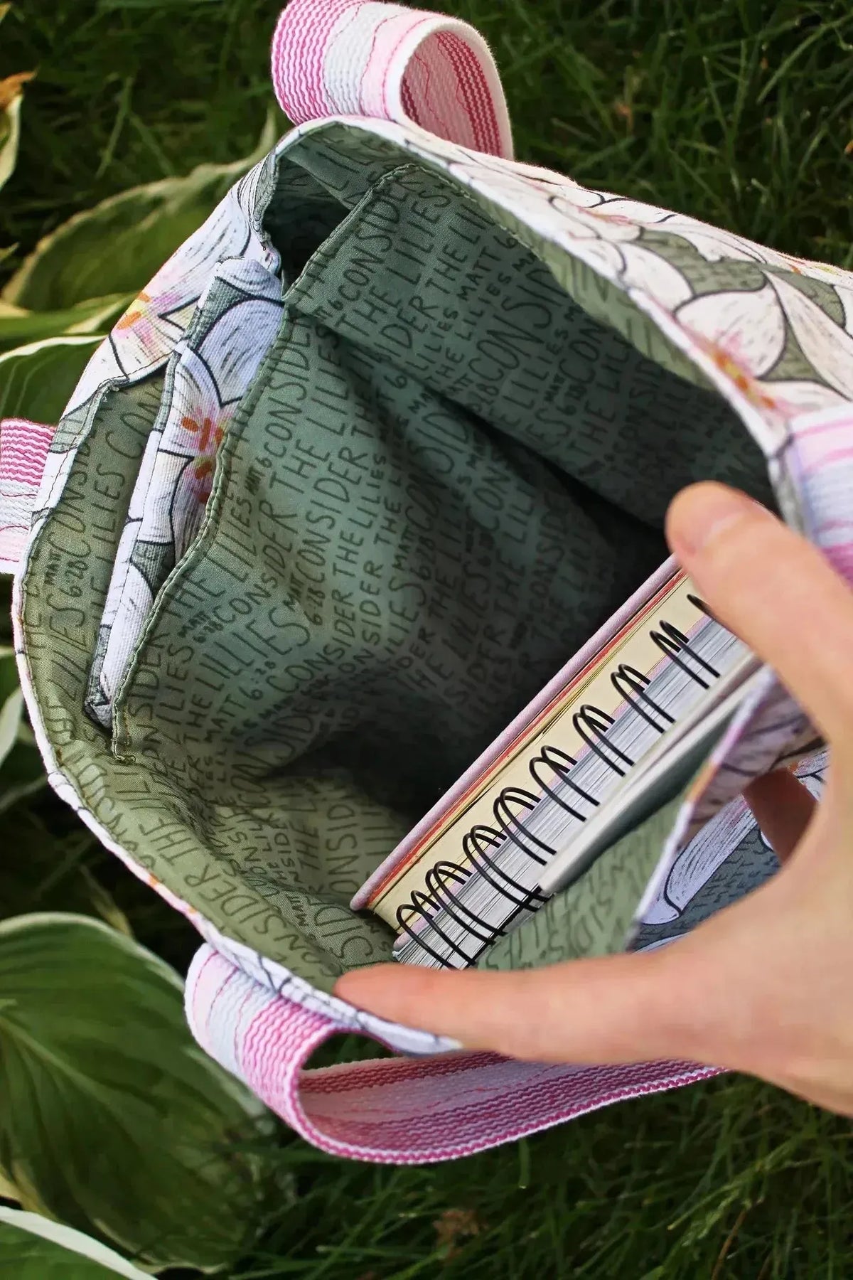 Green floral print fabric from WayMaker's Consider the Lilies collection, shown sewn into a backpack.