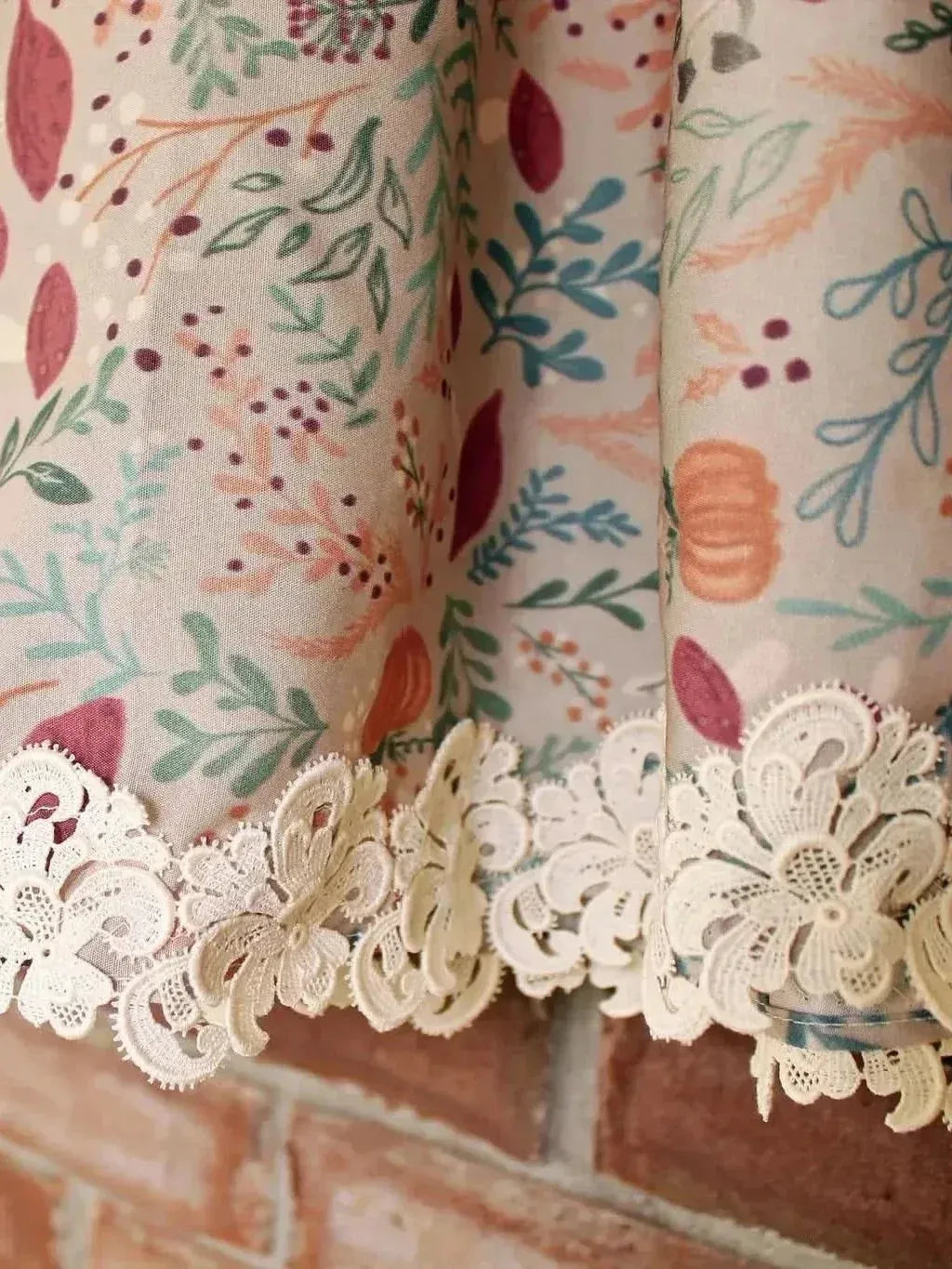 Tan botanical fabric with forest foliage print and lace trim.