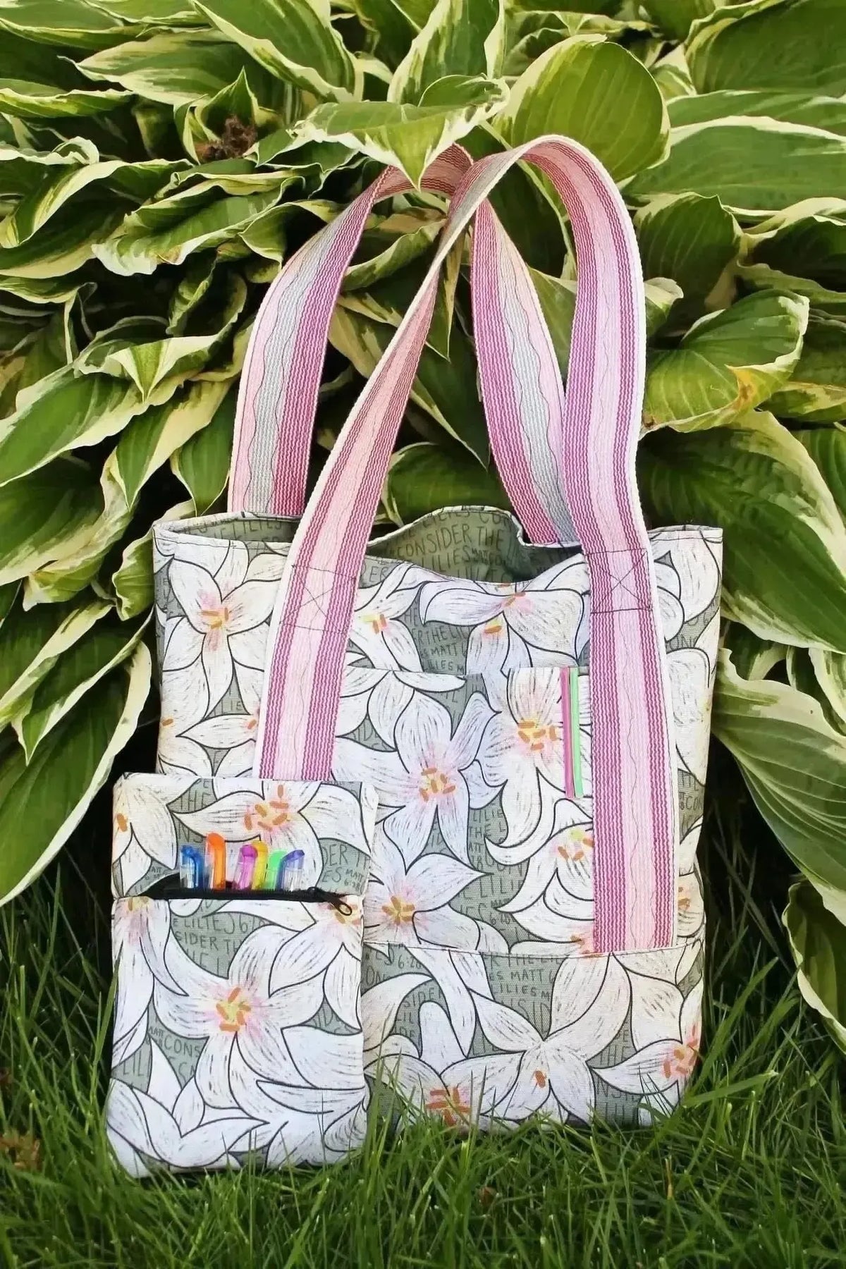 Lilies in green botanical print fabric with white flowers on green background.