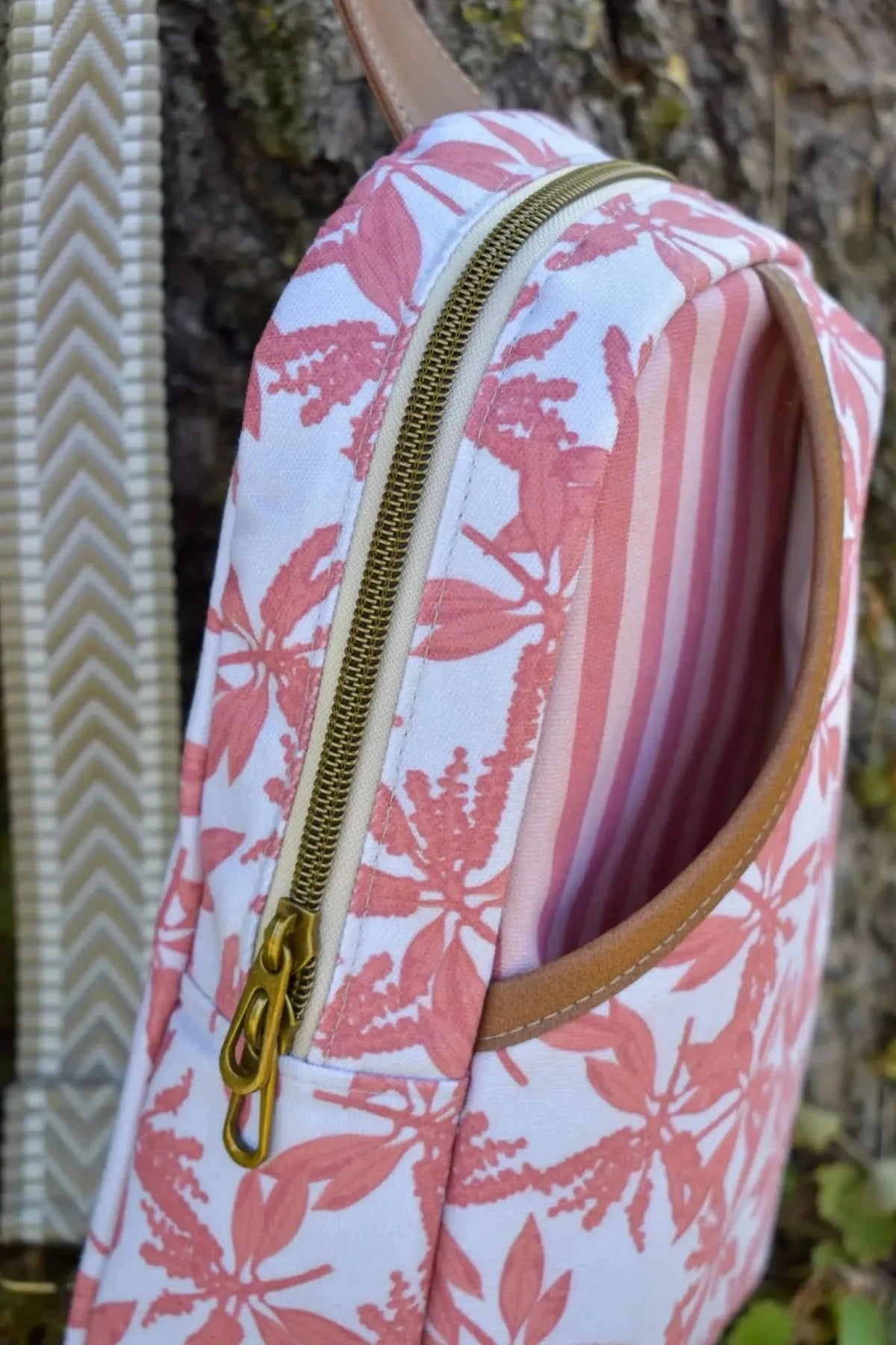 Pink leaves print fabric with autumn floral pattern on white background.