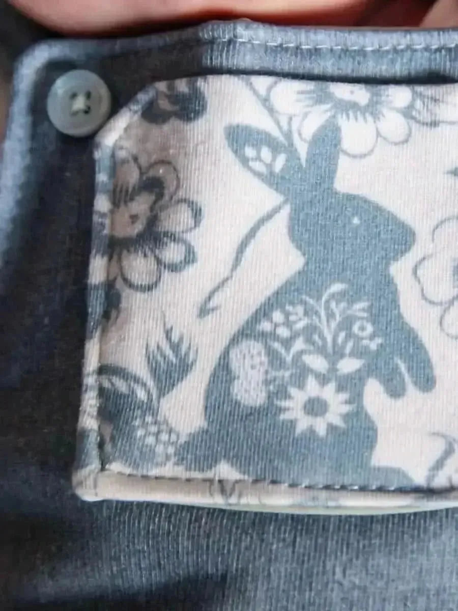 Carolina blue linen fabric with botanical print of flowers and a rabbit.