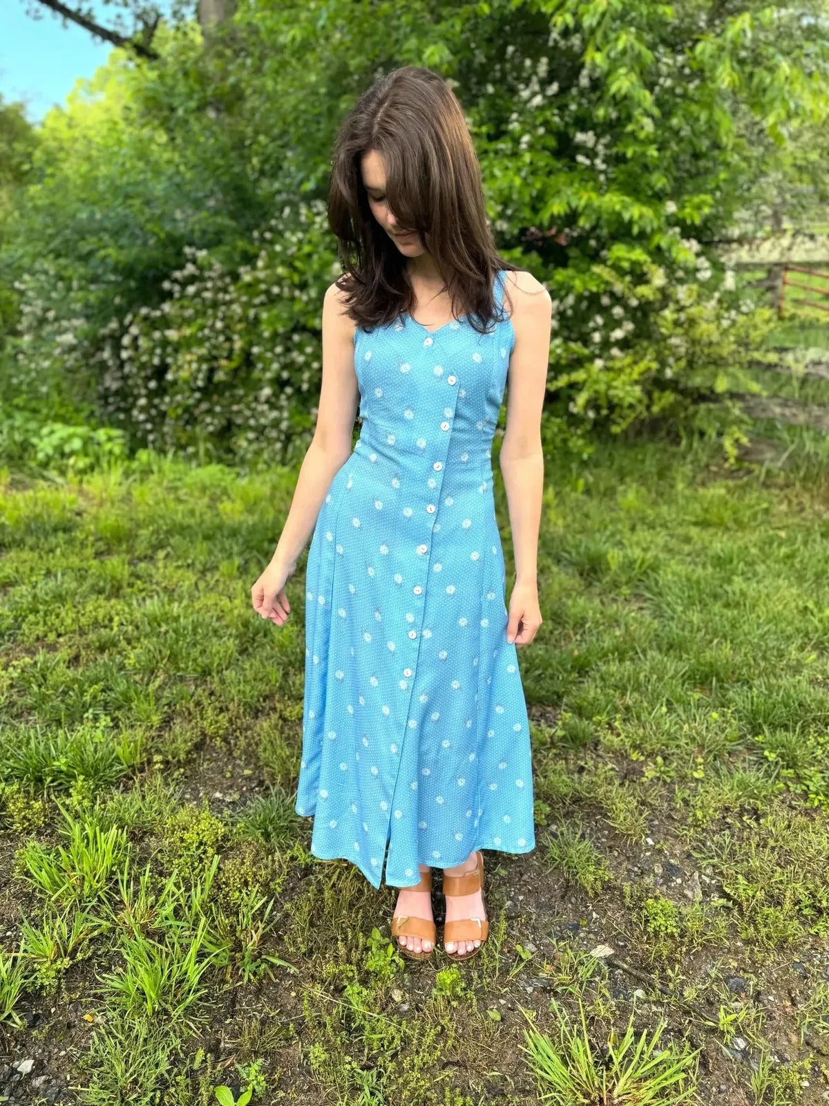 Blue floral print fabric with vintage blooms pattern on light blue background.